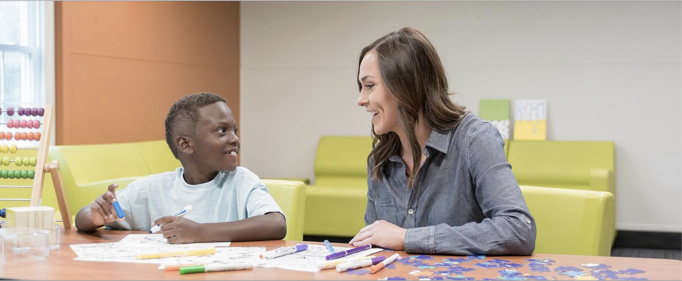 A youth services provider engaging with a child in a community-based behavioral health environment